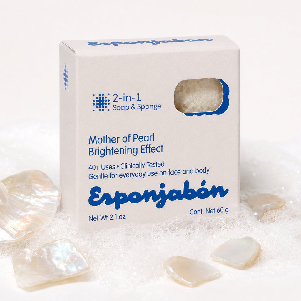 A white box of Esponjabón Mother of Pearl Brightening Effect soap and sponge, surrounded by iridescent mother-of-pearl stones and white powder on a clean white background.